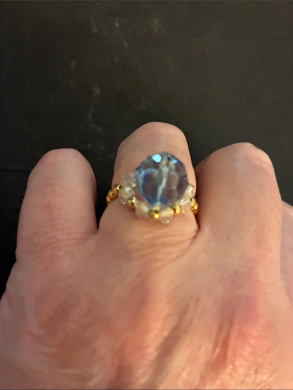 Gold-Tone Stretch Beads.Ring with Light Blue Faceted Stone and Crystal Accents.